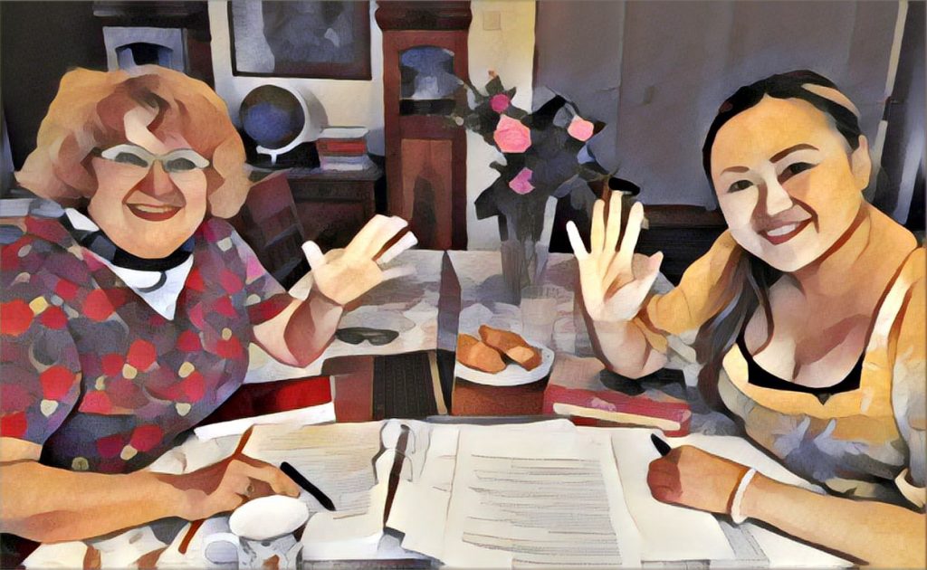 Vaula ja Jenni pöydän ääressä, vilkuttavat