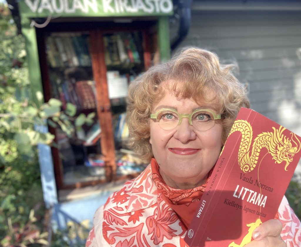 Vaula and Littana book in front of Vaula's free little library